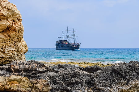 black galleon ship on body of water at daytime thumbnail
