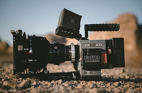 black and gray shoulder-mount camera on ground during daytime thumbnail