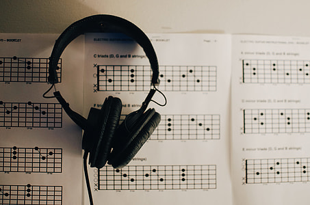 black on-ear headphones on white paper thumbnail