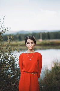 woman posing for picture near body of water at daytime thumbnail
