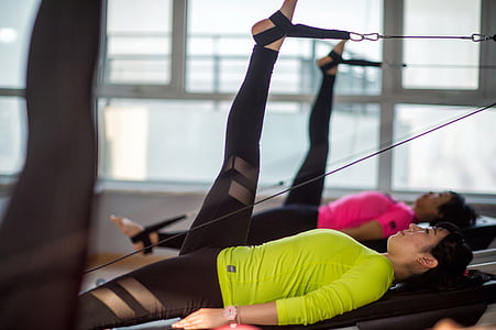 woman performing leg exercise inside gym thumbnail