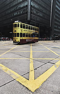 yellow bus near building thumbnail