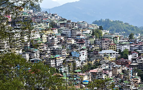 aerial photo of buildings overlooking mountain during daytim,e thumbnail