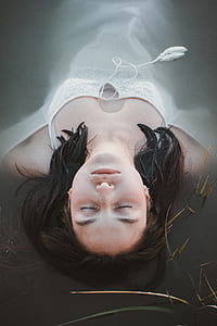 woman floating on body of water thumbnail