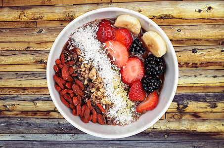 bowl of berries with banana and nuts thumbnail