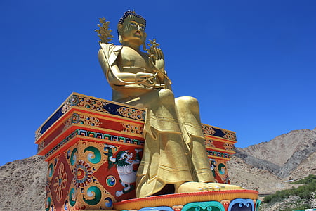 brass Buddha statue under blue sky thumbnail