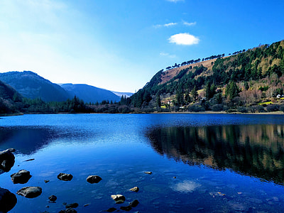 blue lake beside mountain during daytime thumbnail