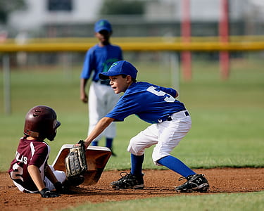 selective focus photography of baseball player in front of another baseball player thumbnail