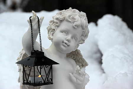 black candle lantern on cherub hand statue thumbnail
