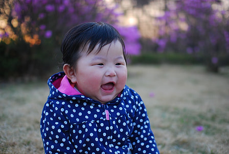 baby wearing black and white polka-dot jacket thumbnail