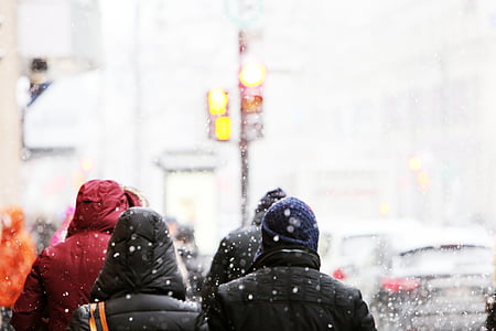 group of people wearing hoodie while walking at middle of street thumbnail
