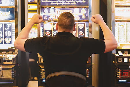 Man playing the slot machine at casino thumbnail