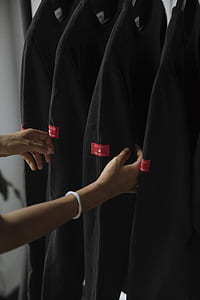 person touching black long-sleeved top thumbnail