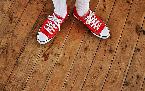 person wearing red-and-white low-top sneakers thumbnail