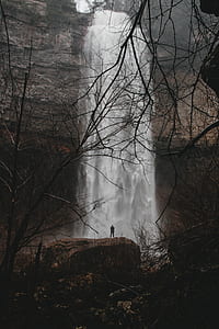 man standing in front of waterfall thumbnail