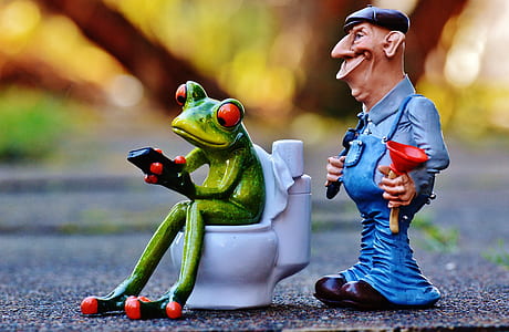selective focus photography of two Kermit the frog and man figurines thumbnail