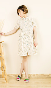 woman standing near wall holding stick thumbnail