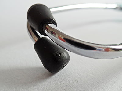 closeup photo of gray and black stethoscope on top of white surface thumbnail