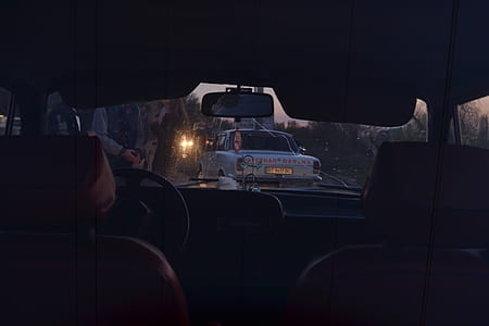 black vehicle interior near white car at daytime thumbnail