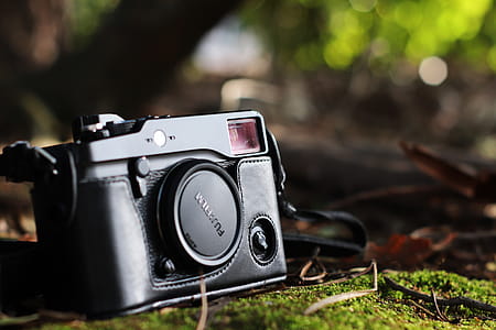 Selective Focus Photo of Black Fujifilm Camera on Ground thumbnail