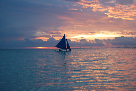 landscape photography of sky, body of water, and sailing boat thumbnail