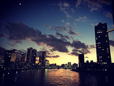 river between buildings during golden hour thumbnail