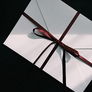 white envelope with maroon ribbon thumbnail