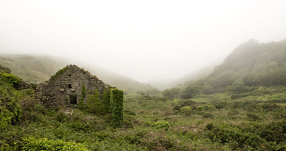 green brick building in a distance of mountain thumbnail