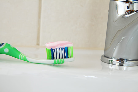 closed up photo of green and white toothbrush thumbnail