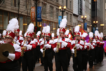 marching band on road near building at daytime thumbnail