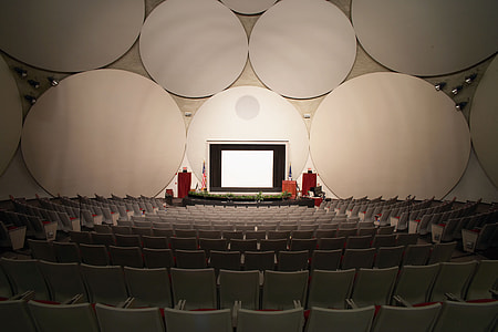 photography of stage and white chairs thumbnail