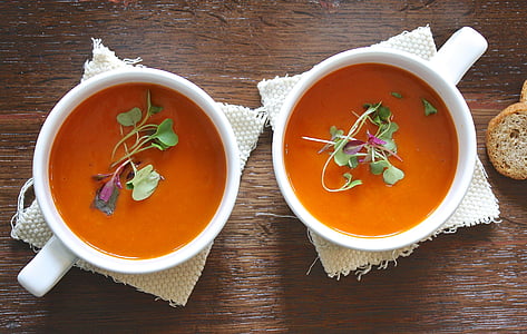 two white ceramic cup with soup and vegetable thumbnail
