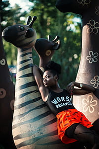 Woman Leaning on Zebra Statue thumbnail