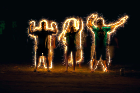steel wool photography of three persons standing thumbnail