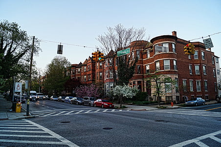 brown brick building in near road with traffic light thumbnail