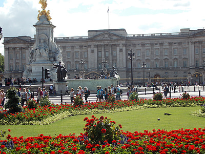 people walking and standing in front of building and statue during day thumbnail