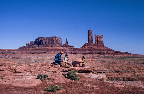 Two Children with One Adult of native american tribe playing at Monument Valley in Arizona thumbnail