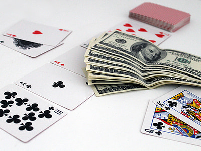 100 US dollar banknote collection on white surface beside playing cards thumbnail