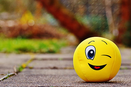 yellow emoji ball on floor at daytime thumbnail