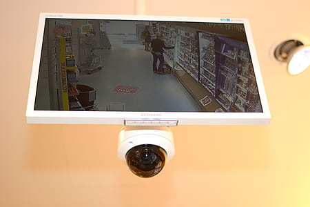 white Samsung flat screen CCTV monitor with turned-on screen thumbnail