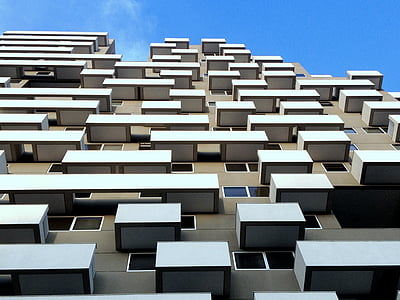 low-angle photography of brown and white condominium during daytime thumbnail