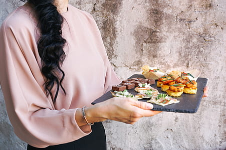 woman holding cooked foot on black tray thumbnail