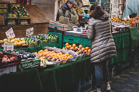 photo of woman standing front of fruit market thumbnail