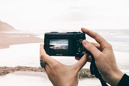 Person Taking Picture of Sea Using Point-and-shoot Camera thumbnail