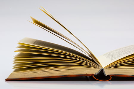 book opened on white surface thumbnail