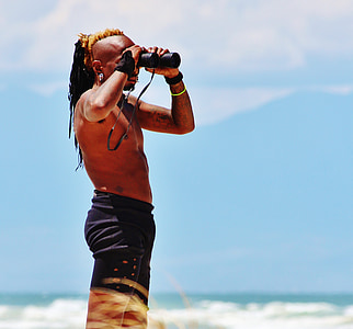 man using binoculars at daytime thumbnail