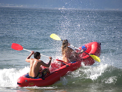 man and woman paddling in inflatable boat thumbnail