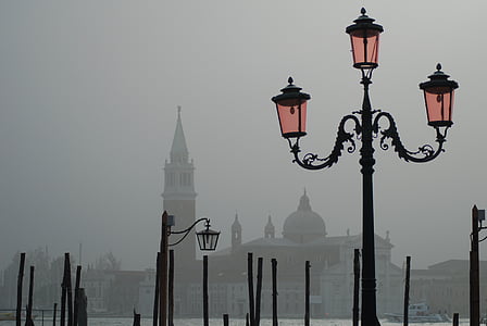 black 3-bulb street light near body of water thumbnail