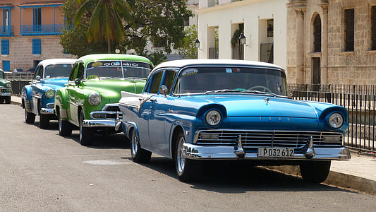 two blue and one green parked vintage cars thumbnail