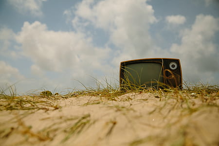 vintage black television on brown sand thumbnail